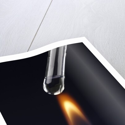 Test tube with liquid, over flame by Anonymous