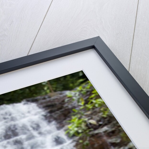 Woman meditating in front of a waterfall by Anonymous