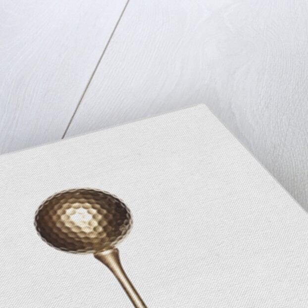 Gold golf ball and tee by Anonymous