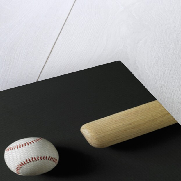 Directly-above view of a bat and a ball in a row by Anonymous