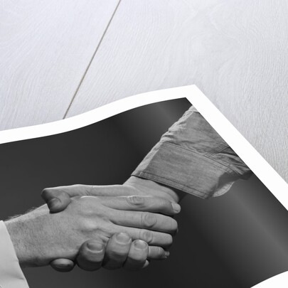 Close-up handshake between businessman and laborer by Anonymous