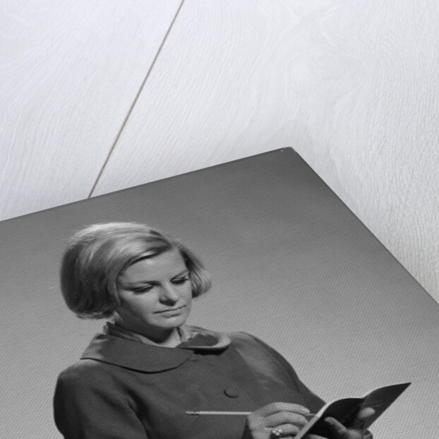Blond woman secretary teacher taking notes by Anonymous