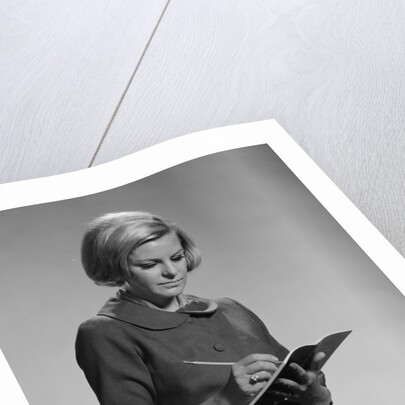 Blond woman secretary teacher taking notes by Anonymous