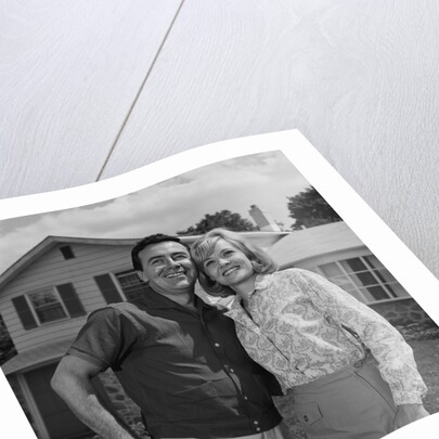 Happy couple portrait man woman smiling in front of home by Anonymous