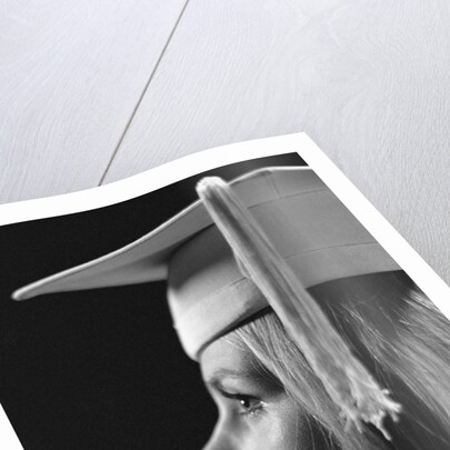 Profile blond female graduate wearing white mortarboard by Anonymous