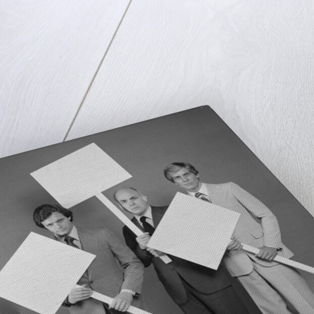 Trio of businessmen carrying blank signs by Anonymous