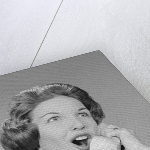Excited woman talking on telephone by Anonymous