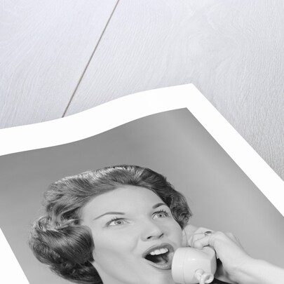 Excited woman talking on telephone by Anonymous