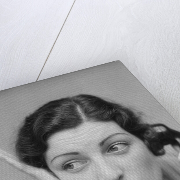 Young brunette woman with surprised expression hand to head talking on telephone by Anonymous