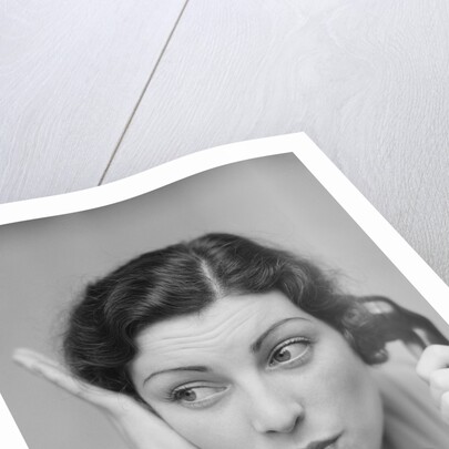 Young brunette woman with surprised expression hand to head talking on telephone by Anonymous