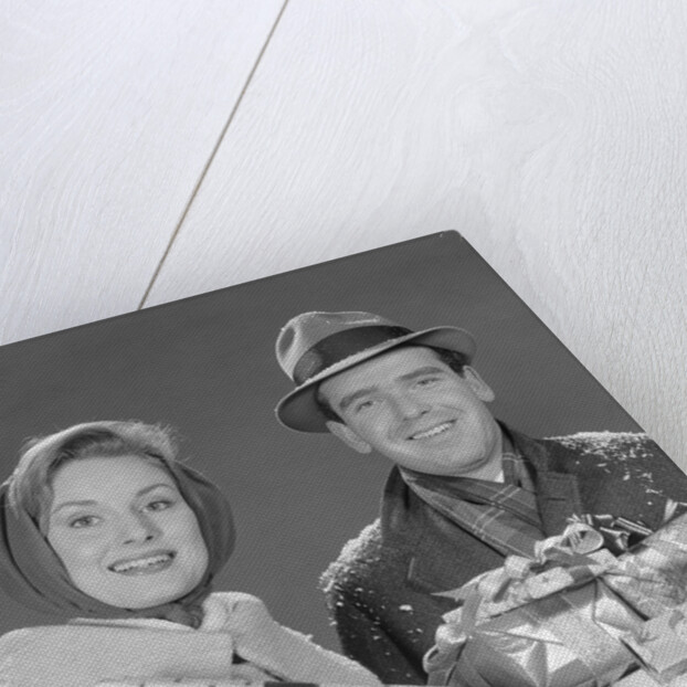 Couple man and woman holding wrapped christmas presents and packages by Anonymous