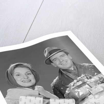 Couple man and woman holding wrapped christmas presents and packages by Anonymous