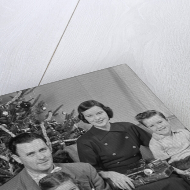 Family portrait by christmas tree by Anonymous