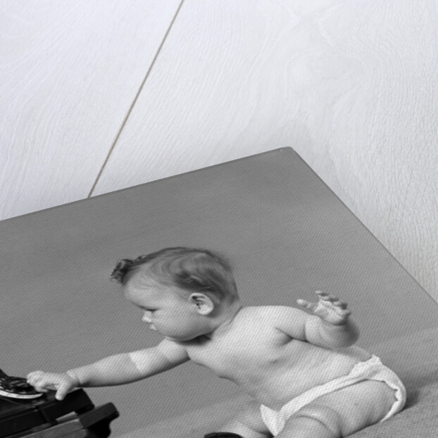 Baby in diaper dialing telephone by Anonymous