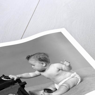 Baby in diaper dialing telephone by Anonymous