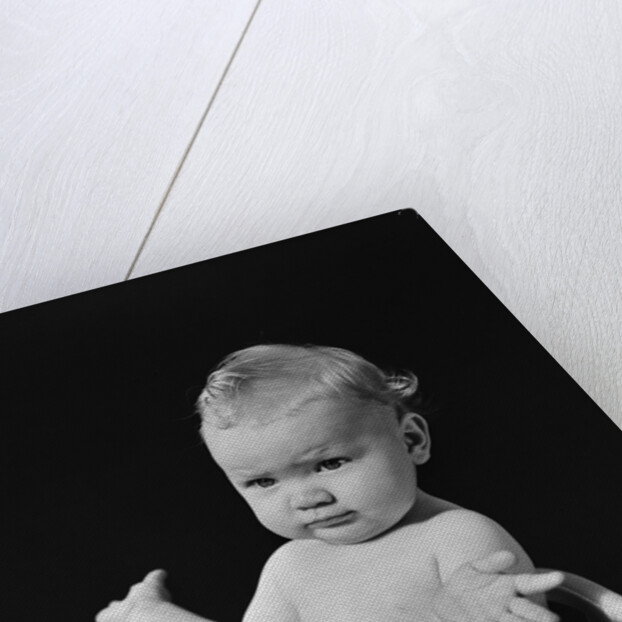 Baby in high chair making shrugging gesture by Anonymous