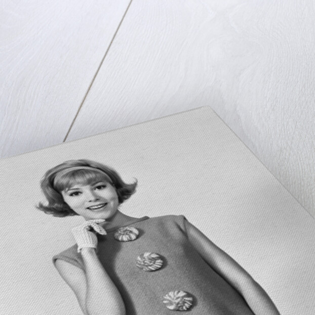 Smiling stylish young woman wearing sack dress gloves by Anonymous