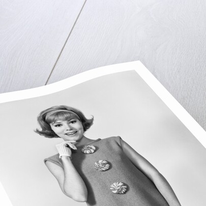 Smiling stylish young woman wearing sack dress gloves by Anonymous