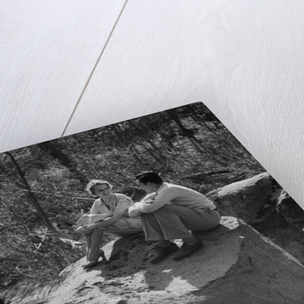 Couple man woman sitting on large rock in stream hugging knees smiling happy romance by Anonymous