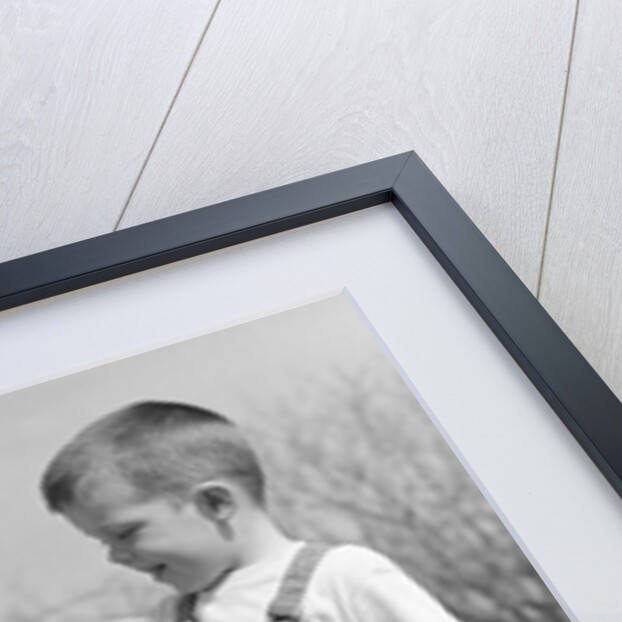 Boys in striped overalls holding piglet by Anonymous