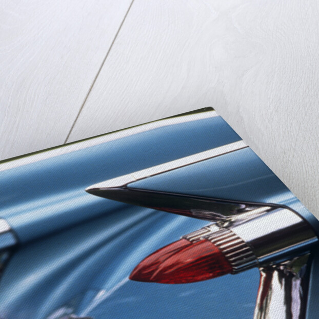 Detail fins rear tail lights blue cadillac auomobile by Anonymous