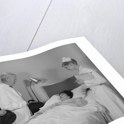 Doctor nurse husband talking with female patient in hospital bed by Anonymous