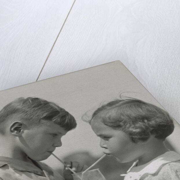 Children boy girl sharing drinking glass using straws by Anonymous