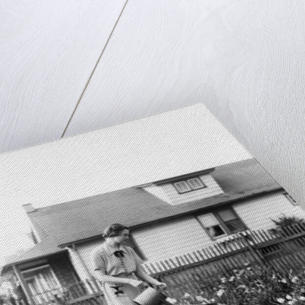 Woman watering garden with water can by Anonymous