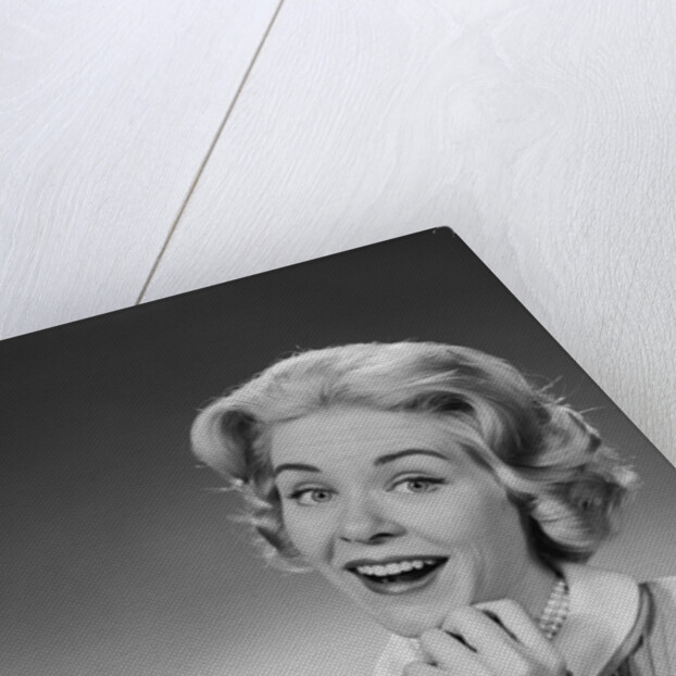 Woman clasped hand by chin with wishful hoping happy joyful facial expression by Anonymous