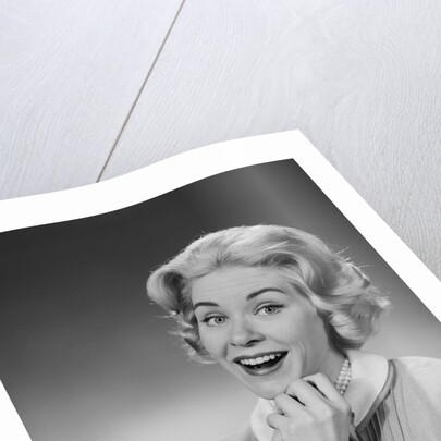 Woman clasped hand by chin with wishful hoping happy joyful facial expression by Anonymous