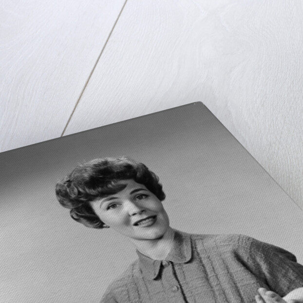 Brunette woman knit dress offhand gesture serious expression by Anonymous