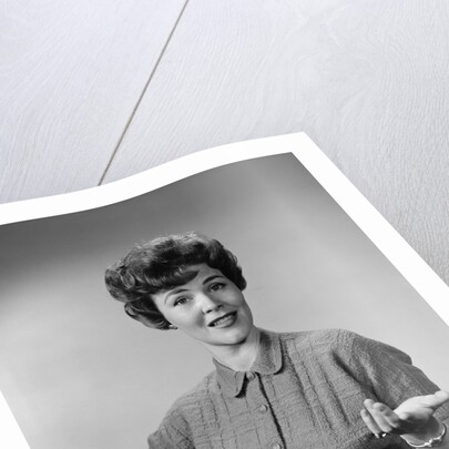 Brunette woman knit dress offhand gesture serious expression by Anonymous