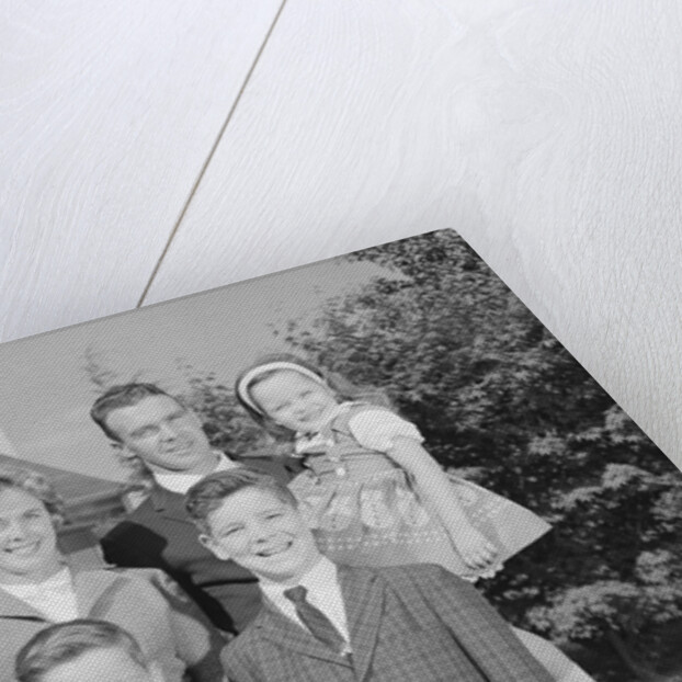 Family portrait father mother two sons and daughter in front of suburban house by Anonymous