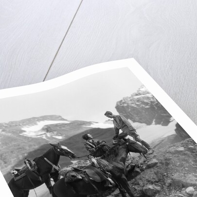 Couple man woman wearing riding gear jodhpurs boots spurs sitting standing on large rock by two horses by Anonymous
