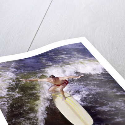 Young man red swim trunks yellow surfboard riding a wave surfing by Anonymous