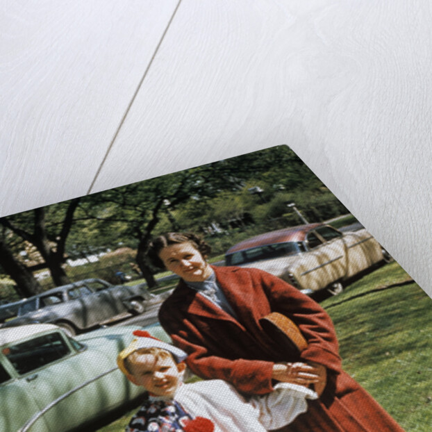 Mother with son dressed in clown suit outdoors by Anonymous