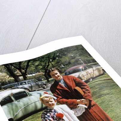 Mother with son dressed in clown suit outdoors by Anonymous