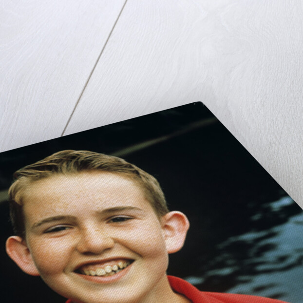 Portrait young boy in red shirt smiling by Anonymous