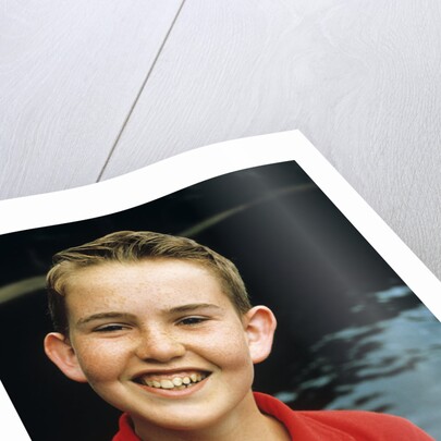 Portrait young boy in red shirt smiling by Anonymous