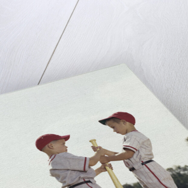 Two boys holding baseball bat little league uniforms by Anonymous