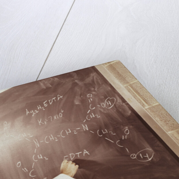 Science professor writing a formula for chelating agent on chalkboard by Anonymous