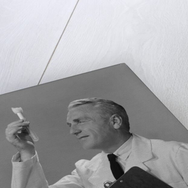 Man scientist studying test tube by Anonymous