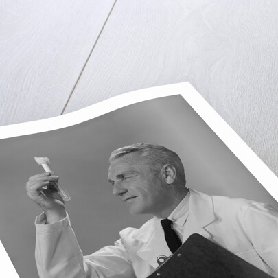 Man scientist studying test tube by Anonymous