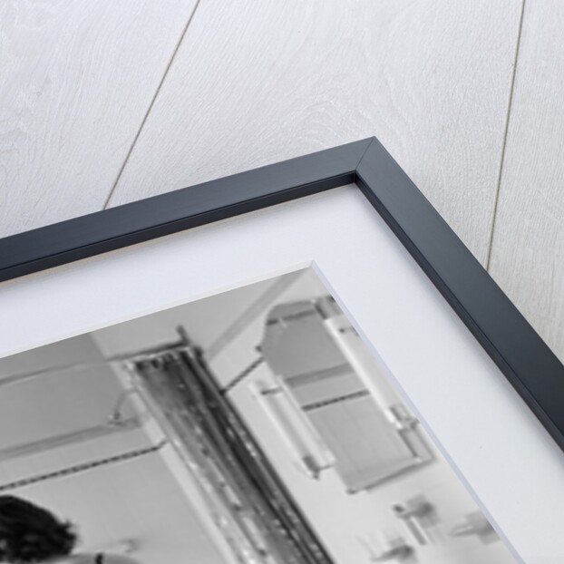 Back view of woman in bathroom fastening black bra by Anonymous