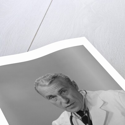 Male doctor holding stethoscope by Anonymous