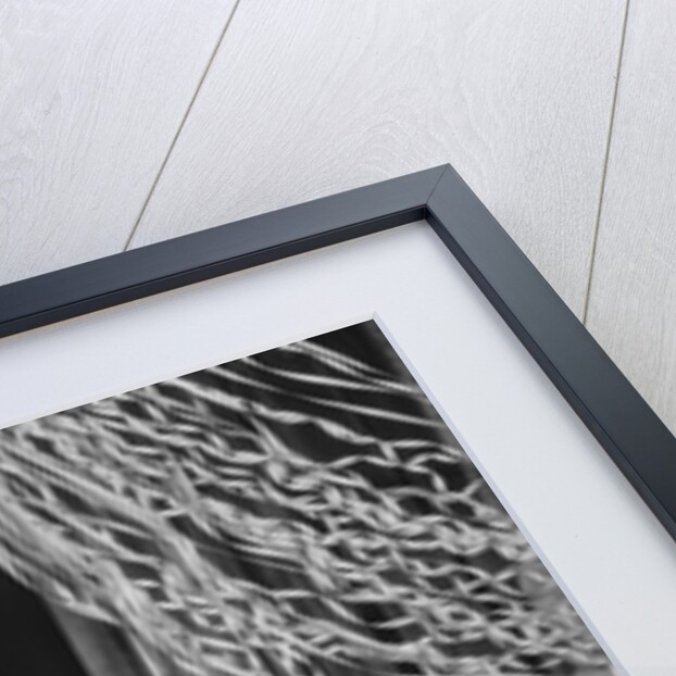 Woman dressed in harlequin costume sitting on stack of balloons by Anonymous