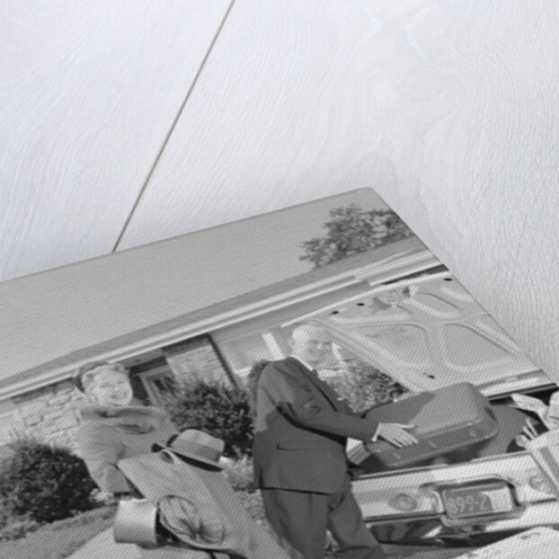 Senior man woman husband wife packing trunk with luggage by Anonymous