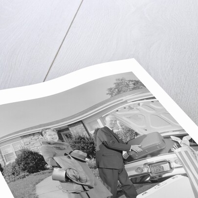 Senior man woman husband wife packing trunk with luggage by Anonymous