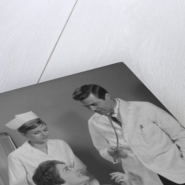 Man doctor woman nurse talking to smiling female patient sitting in hospital wheelchair by Anonymous