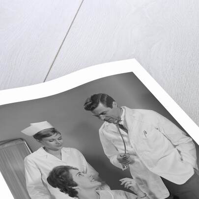 Man doctor woman nurse talking to smiling female patient sitting in hospital wheelchair by Anonymous
